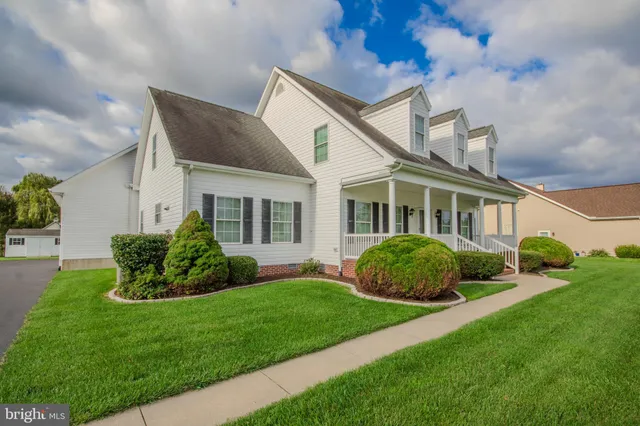 a front view of a house with a garden and plants