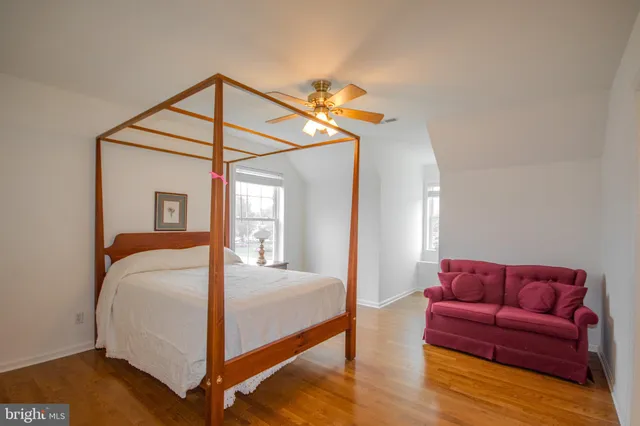 a bedroom with a bed couch and a window