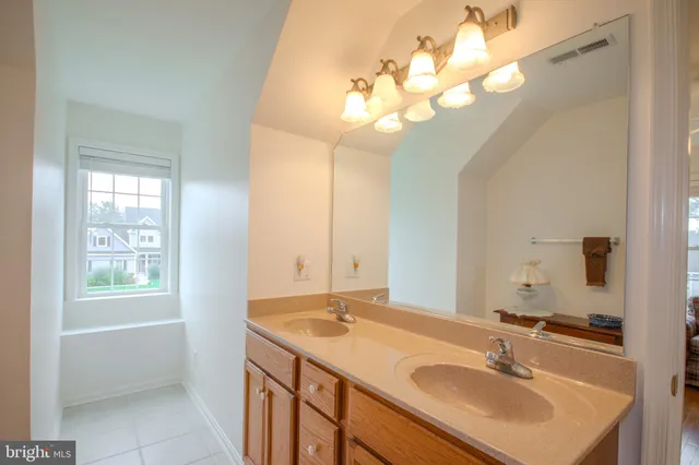 a bathroom with a sink a vanity and a mirror