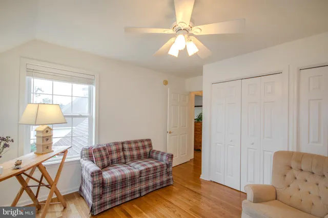 a living room with furniture and a lamp