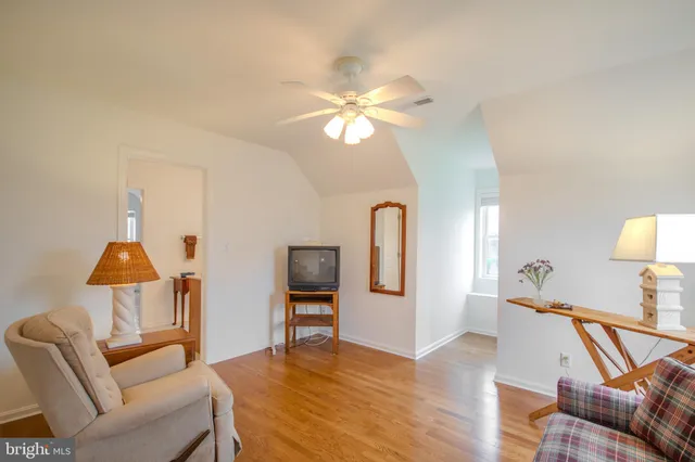 a view of a livingroom with furniture and a chandelier fan