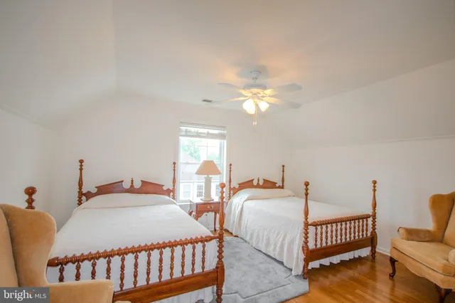 a bedroom with two beds and a chandelier
