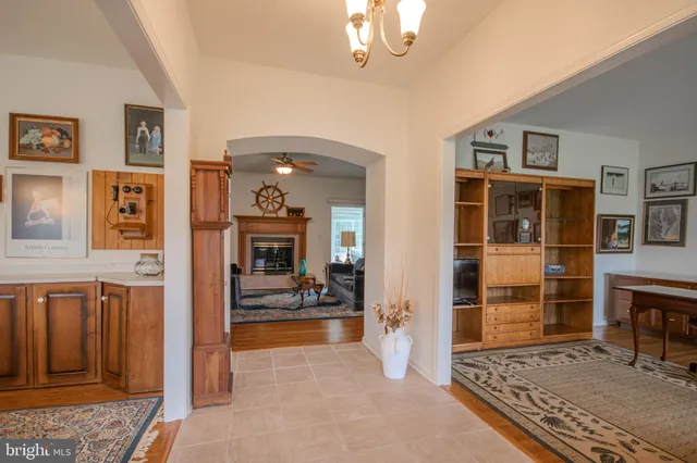 a living room with furniture a rug and kitchen view