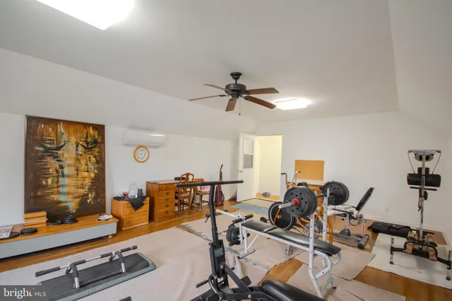 a view of a house with a big yard and a large tree