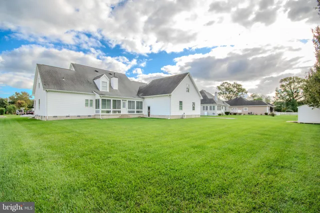 a view of a field of grass and trees