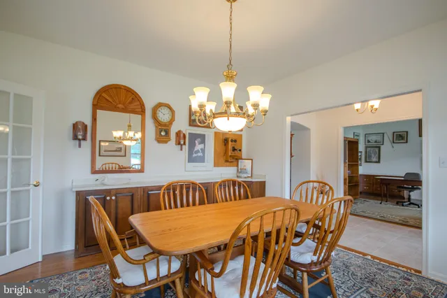 a view of a dining room with furniture and chandelier
