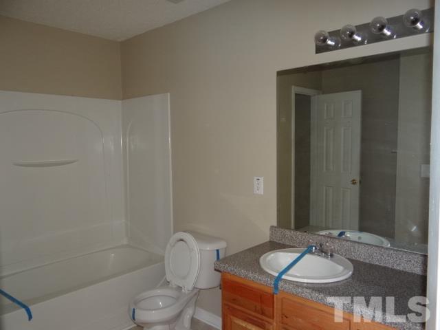 4027 Flat Sedge Lane Raleigh, NC 27604 - Photo 8 of 11 a bathroom with a sink a toilet and shower