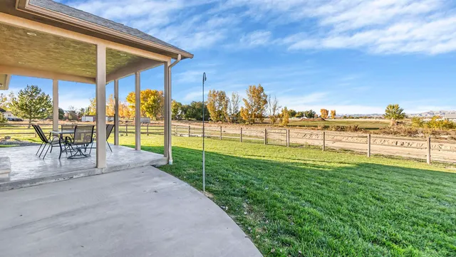 a view of a patio with a table chairs and balcony