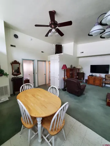 a dining room with furniture and a chandelier