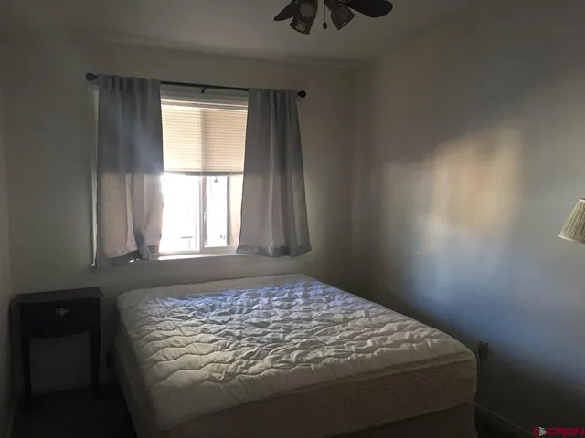 a bed sitting in a bedroom next to a window