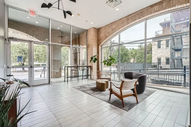 a living room with furniture and a floor to ceiling window