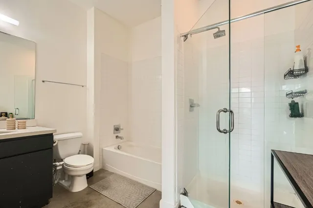 a bathroom with a toilet a sink and shower