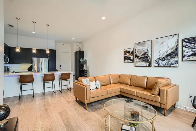 a view of living room kitchen with furniture and wooden floor
