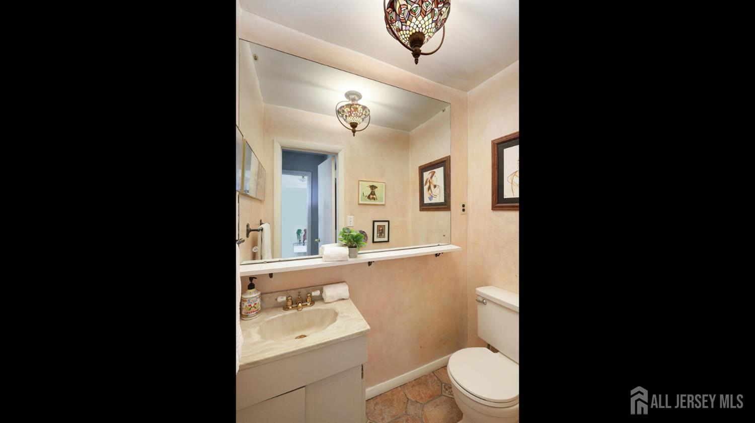 10 Bruning Road East Brunswick, NJ 08816 - Photo 25 of 40 a bathroom with a sink a toilet a mirror and shower