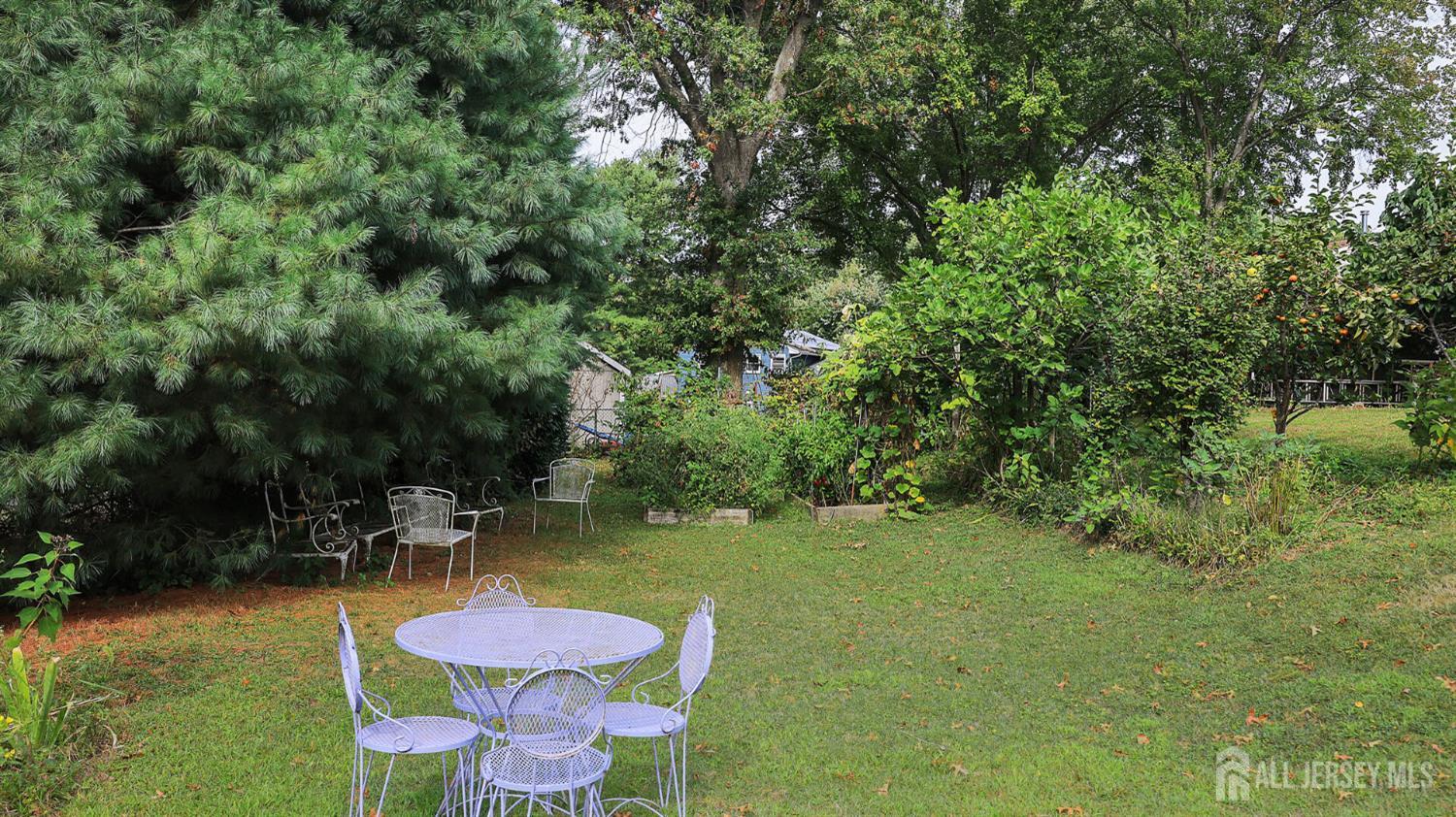10 Bruning Road East Brunswick, NJ 08816 - Photo 34 of 40 a view of a swimming pool with lawn chairs under an umbrella