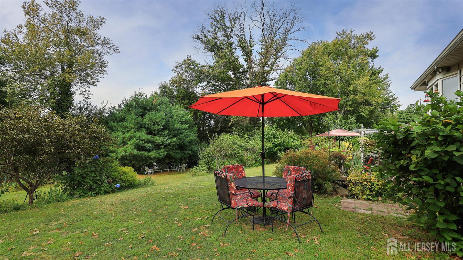 10 Bruning Road East Brunswick, NJ 08816 - Photo 38 of 40 an outdoor sitting area with furniture and red umbrella
