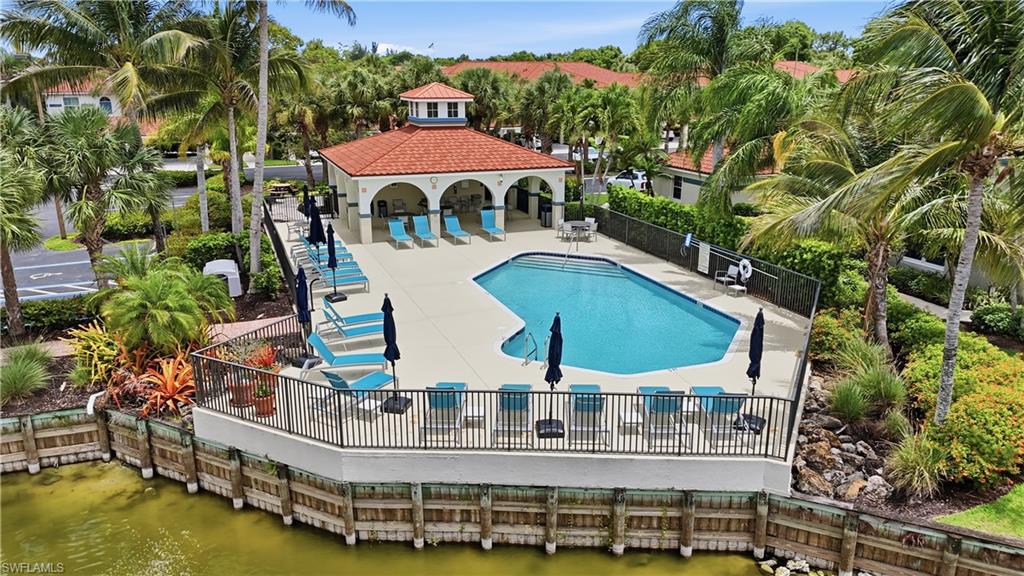 10871 Crooked River Road, Unit 202 Estero, FL 34135 - Photo 39 of 46 an outdoor space with pool and trees