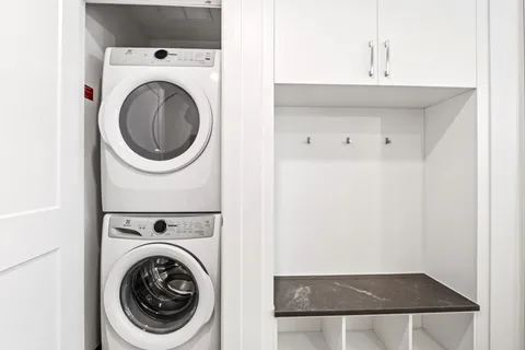 a view of a hallway with washer and dryer
