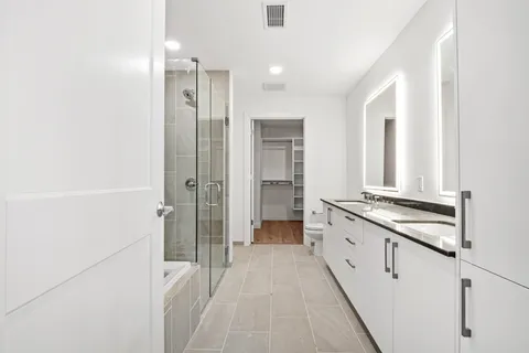 a spacious bathroom with a granite countertop sink and a mirror