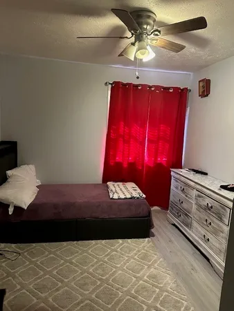 a bedroom with a bed and a dresser in it