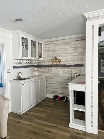 a kitchen with stainless steel appliances granite countertop a stove and white cabinets