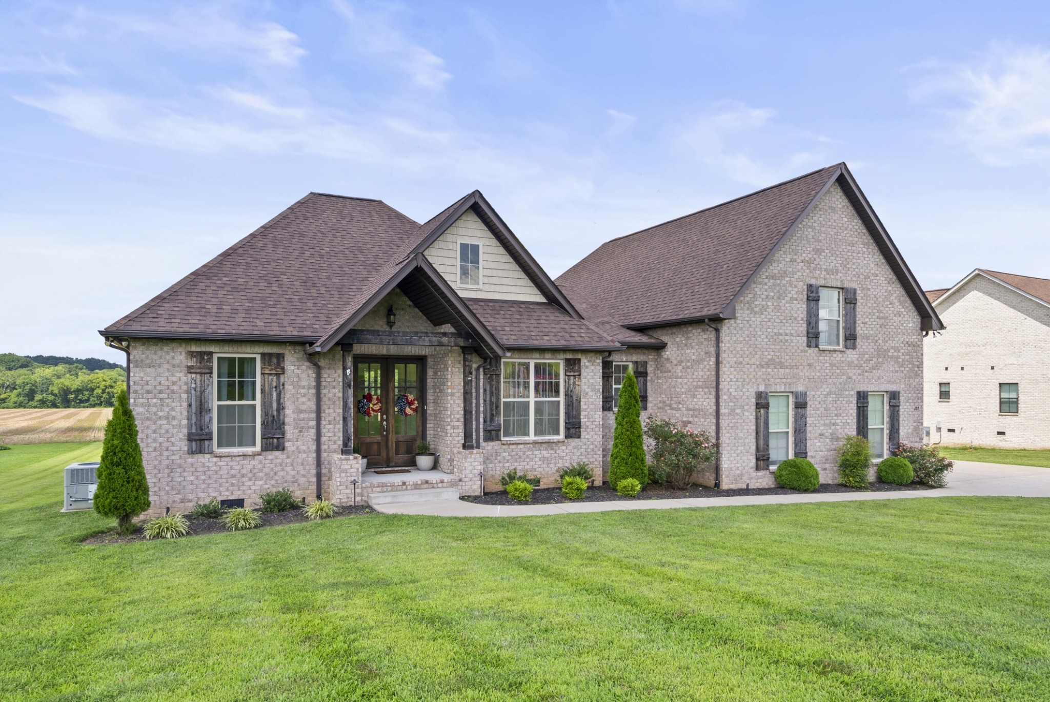 267 Aplin Branch Road Cottontown, TN 37048 - Photo 1 of 56 a front view of a house with a garden and porch