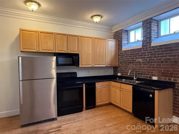 a kitchen with a sink and a refrigerator
