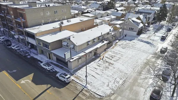 an aerial view of a building with a tree