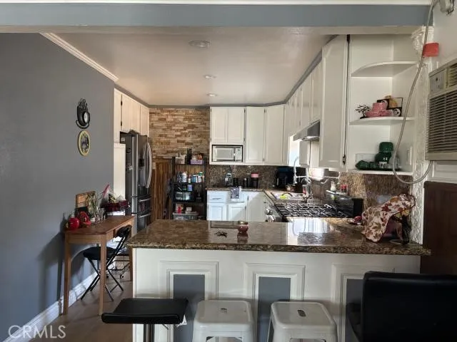 a kitchen with lots of counter top space and furniture
