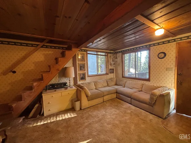 a living room with furniture a ceiling fan and a window