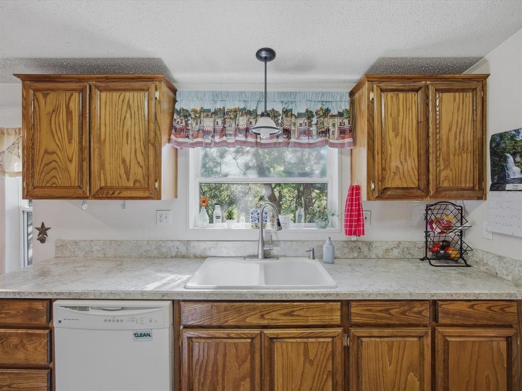 3275 Finis Road Graham, TX 76450 - Photo 11 of 36 a kitchen with a sink cabinets and a window