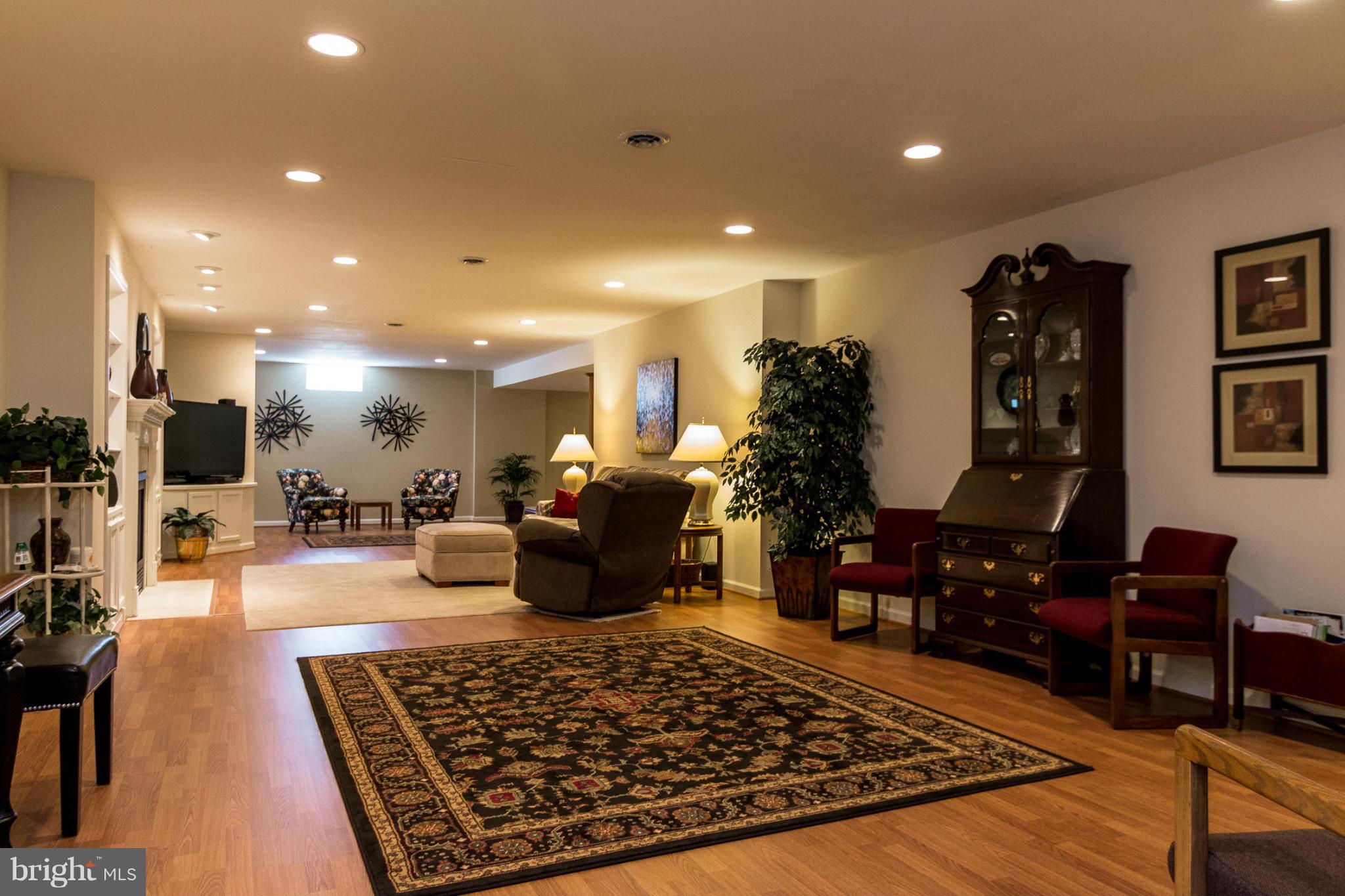 781 Lone Tree Road Westminster, MD 21157 - Photo 21 of 30 a living room with lots of furniture a rug and a chandelier