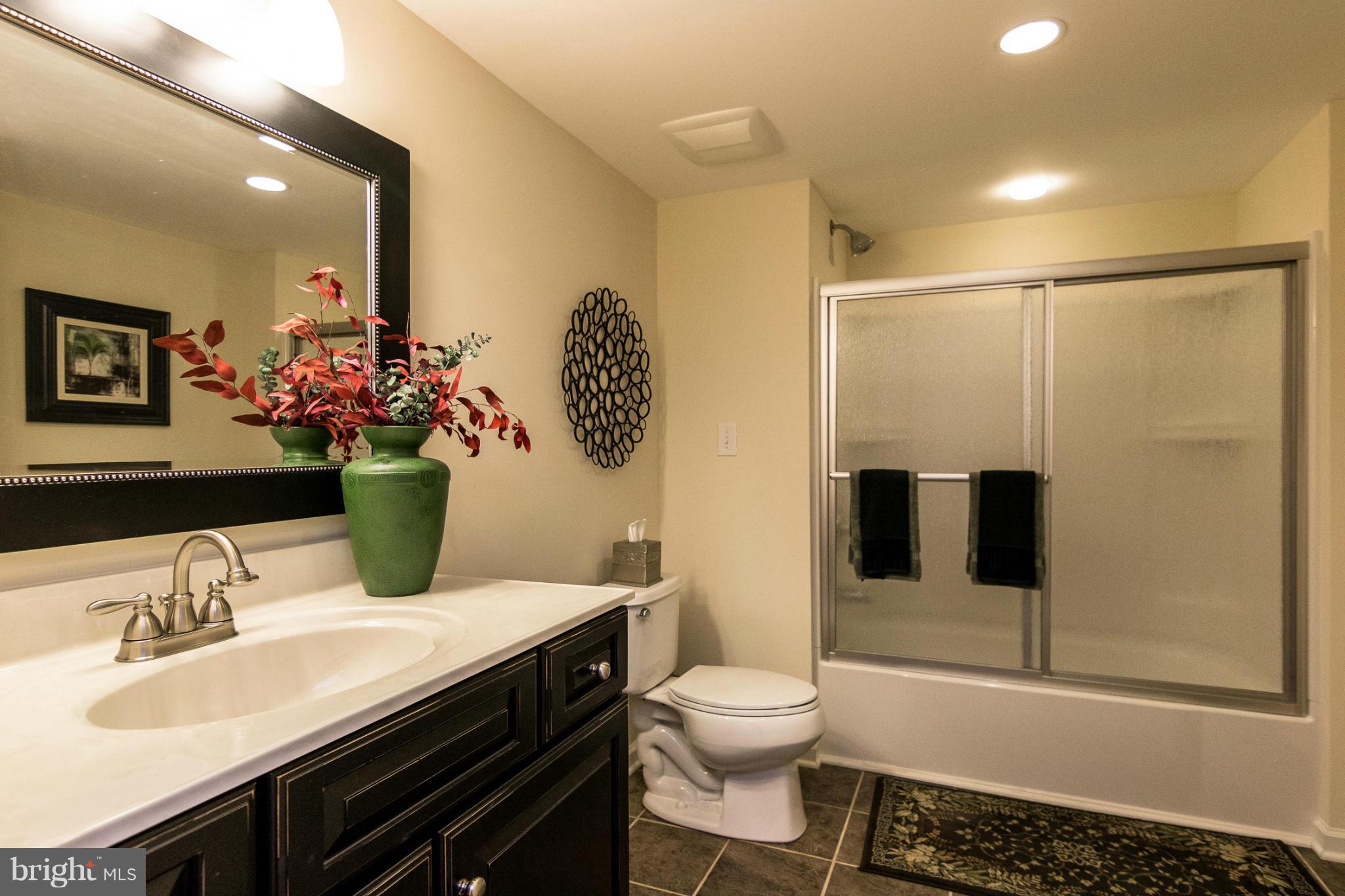 781 Lone Tree Road Westminster, MD 21157 - Photo 22 of 30 a bathroom with a sink toilet and shower