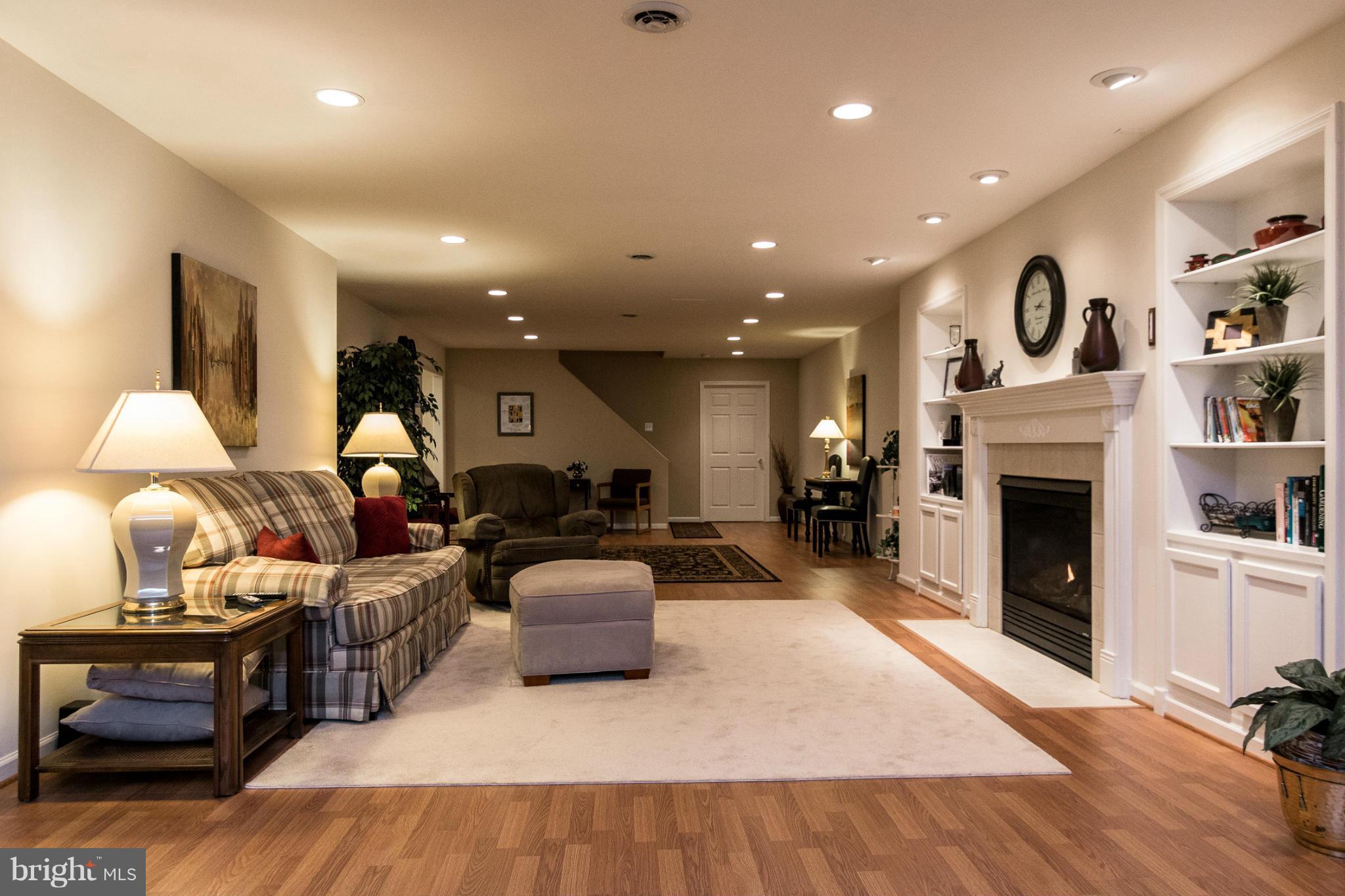 781 Lone Tree Road Westminster, MD 21157 - Photo 23 of 30 a living room with furniture and a fireplace