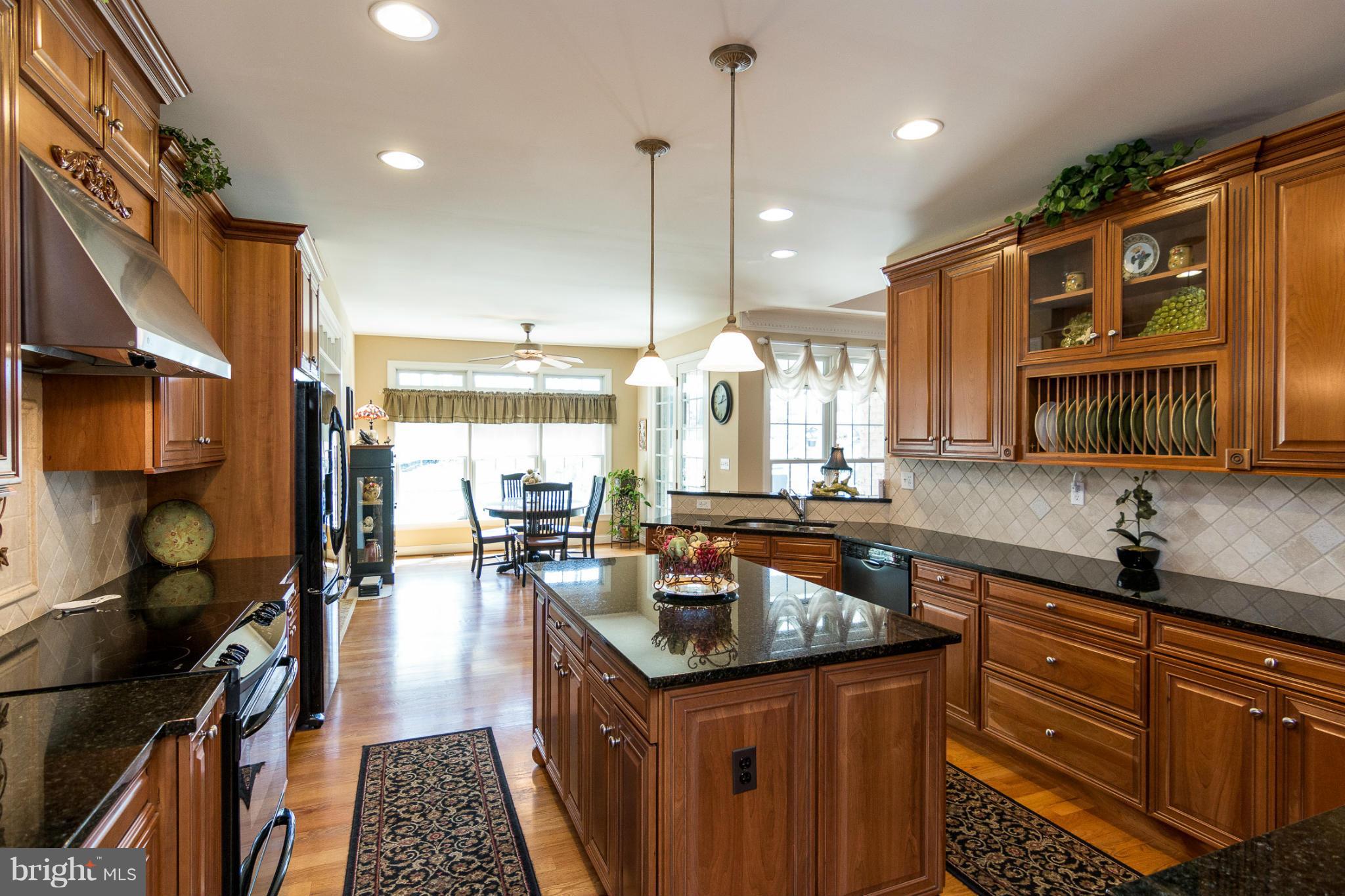 781 Lone Tree Road Westminster, MD 21157 - Photo 6 of 30 a kitchen with a sink stove and cabinets