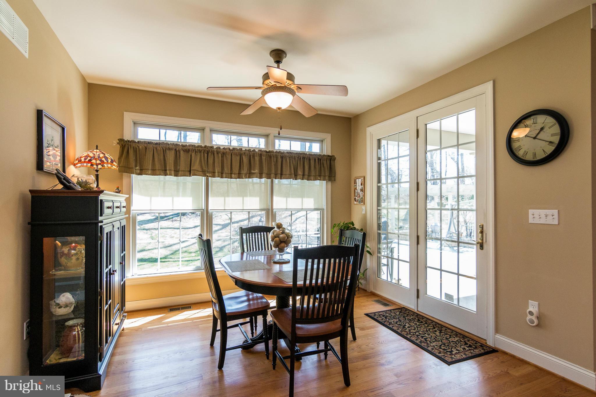 781 Lone Tree Road Westminster, MD 21157 - Photo 7 of 30 a dining room with furniture wooden floor clock and a chandelier