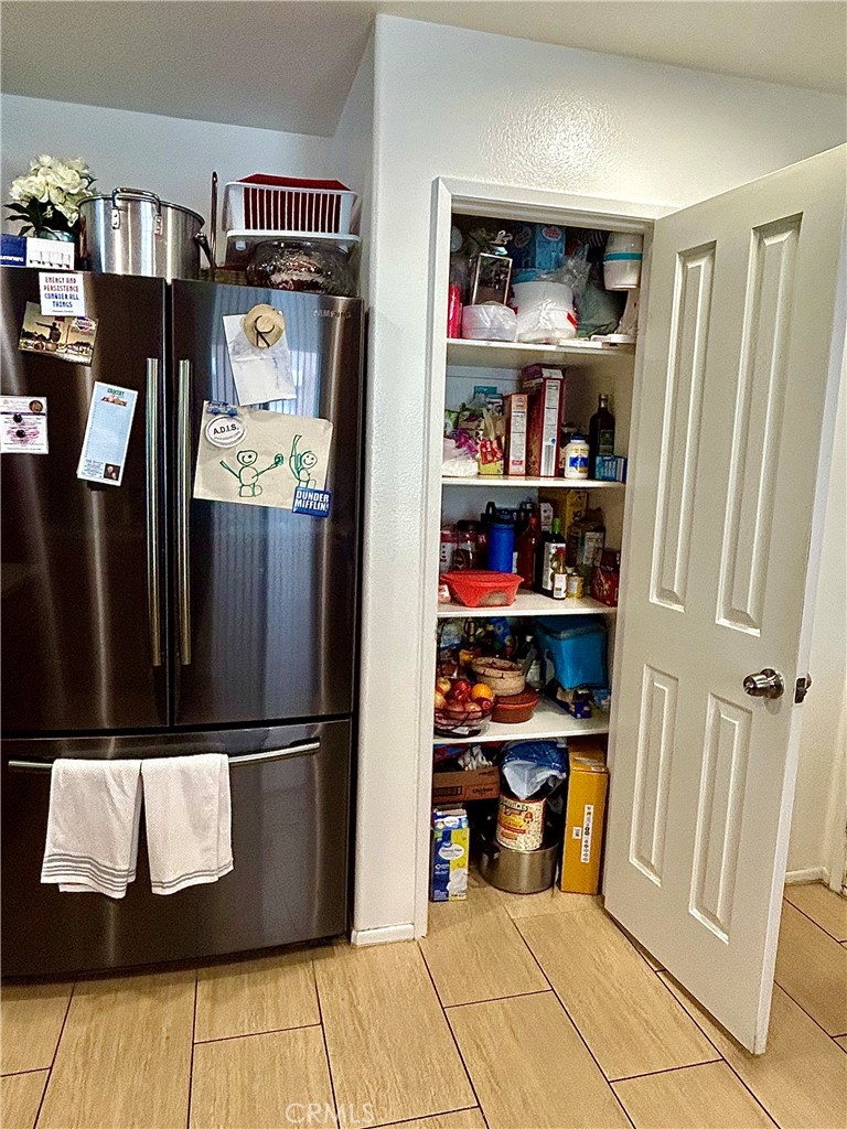 567 Botan Street Perris, CA 92571 - Photo 15 of 38 a view of water heater room with shelves
