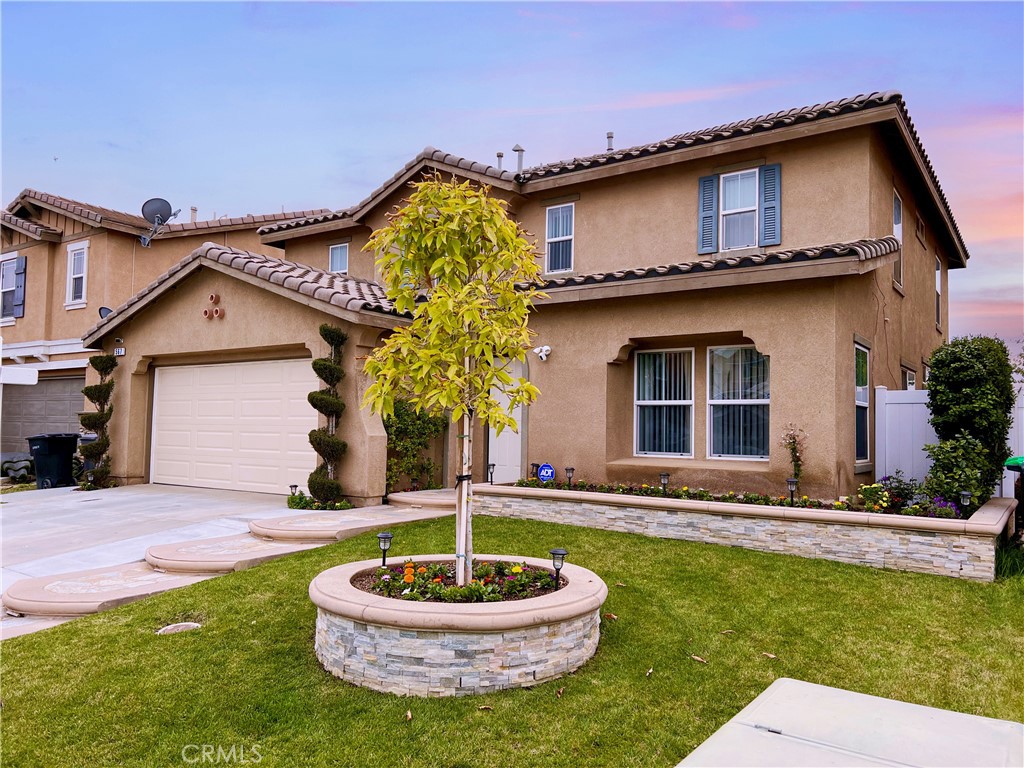 567 Botan Street Perris, CA 92571 - Photo 2 of 38 a front view of a house with a yard