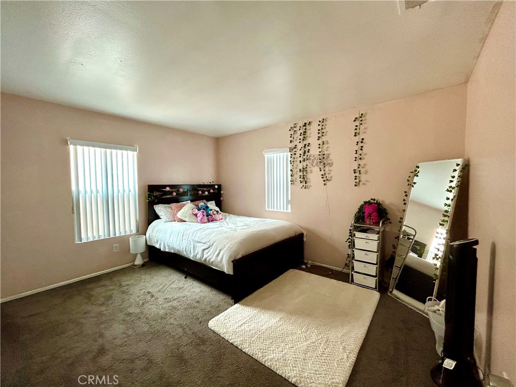 567 Botan Street Perris, CA 92571 - Photo 28 of 38 a bedroom with a bed and a window