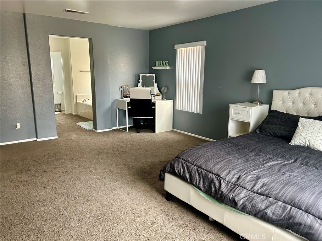 567 Botan Street Perris, CA 92571 - Photo 30 of 38 a bedroom with a bed and dresser