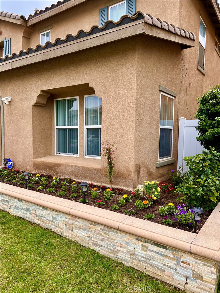 567 Botan Street Perris, CA 92571 - Photo 4 of 38 a front view of a house with a garden