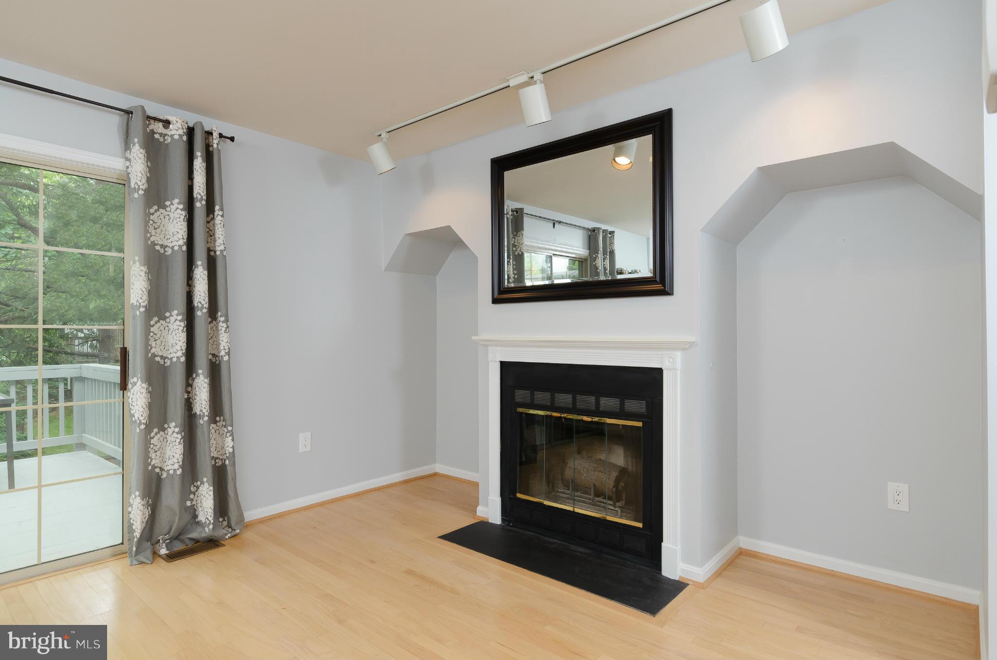728 West Glebe Road Alexandria, VA 22305 - Photo 7 of 28 a living room with a fireplace and a wooden floor