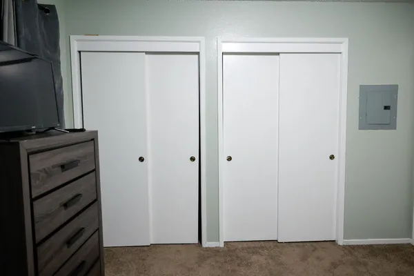 a bedroom with a bed and a chair