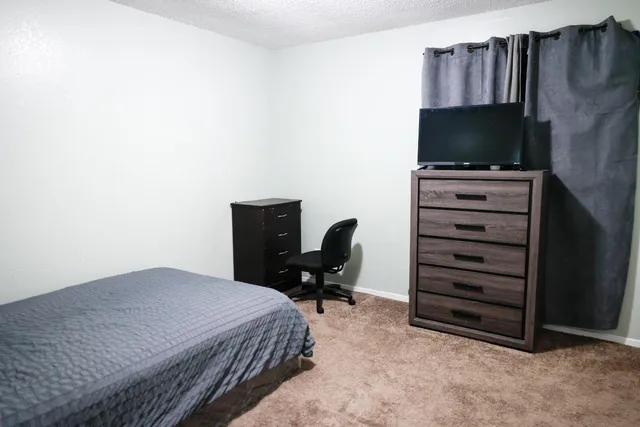 a view of a livingroom with furniture and a window