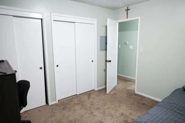 a bedroom with a bed and a flat screen tv