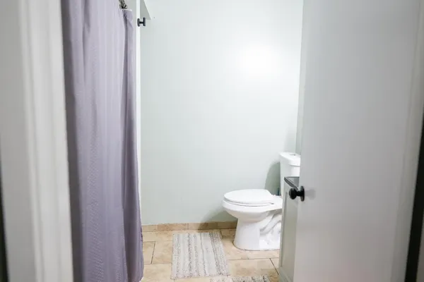 a view of a hallway with wooden floor and closet