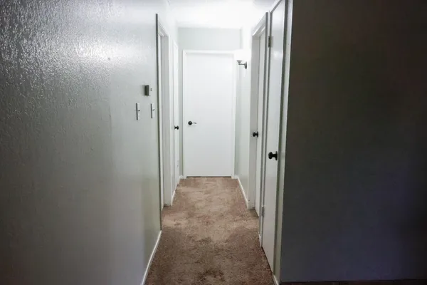 a kitchen with stainless steel appliances kitchen island granite countertop a table chairs and a refrigerator