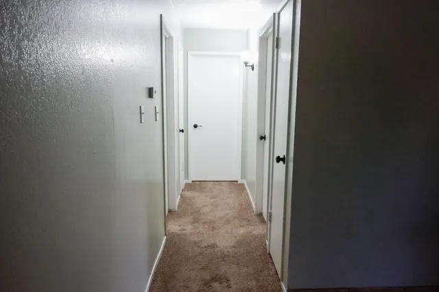 a kitchen with stainless steel appliances kitchen island granite countertop a table chairs and a refrigerator