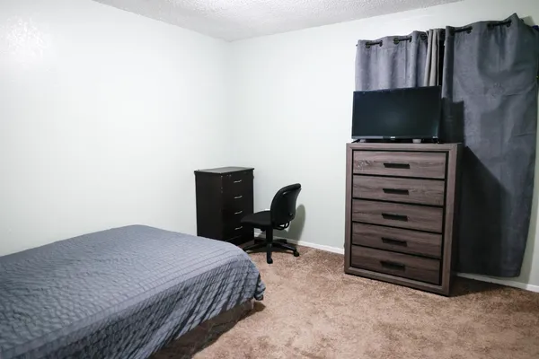 a view of a hallway with wooden floor and closet