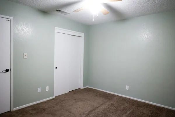 an empty room with closet area
